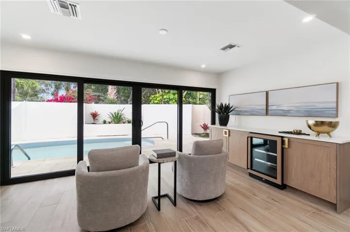Den/sitting area off of the main living space with dry bar and wine cooler