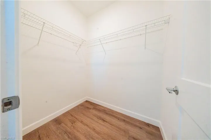 Walk in closet featuring light wood finished floors