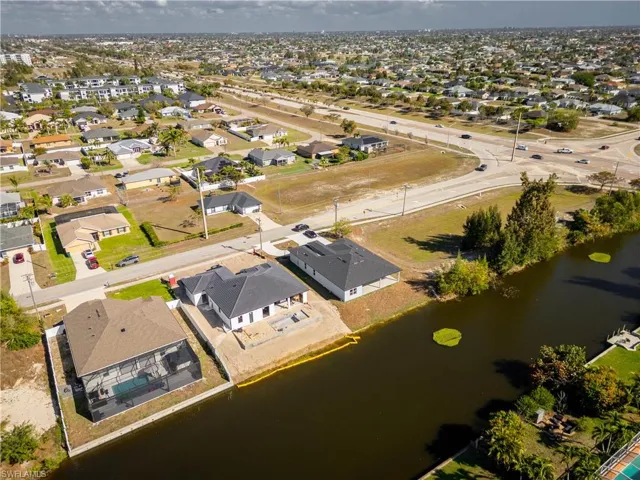 View of property location with a large body of water and nearby suburban area