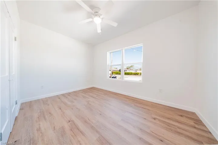 Empty room with light wood-style flooring and a ceiling fan