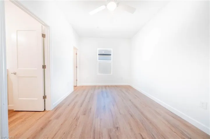 Empty room featuring light wood-style floors and a ceiling fan