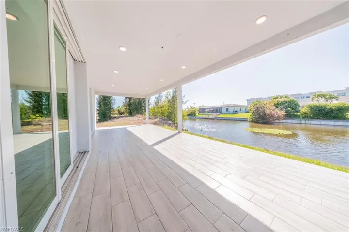 Deck with a water view and a patio area