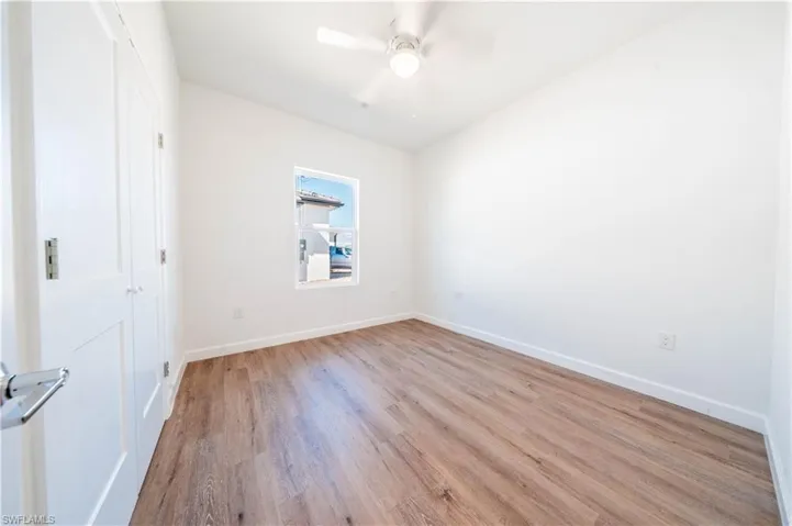 Unfurnished room with light wood-type flooring and a ceiling fan