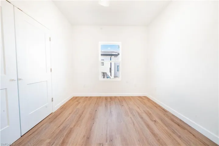 Empty room with light wood-style flooring and baseboards