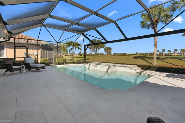 Outdoor pool featuring a sunroom, a lanai, a yard, and a patio area