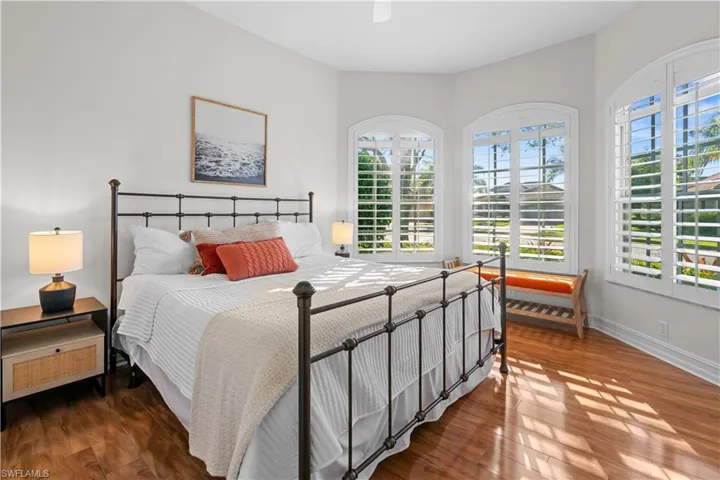 Bedroom featuring a ceiling fan and dark wood-type flooring