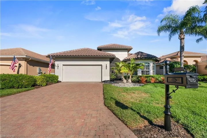 Mediterranean / spanish-style house with stucco siding, a front lawn, decorative driveway, an attached garage, and a tile roof
