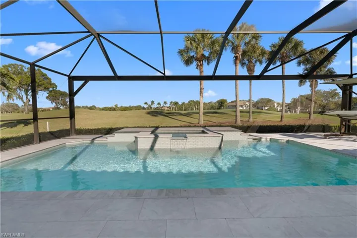 View of pool featuring a lanai and a pool with connected hot tub