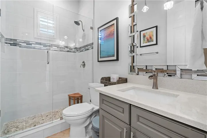 Full bathroom with vanity and a stall shower