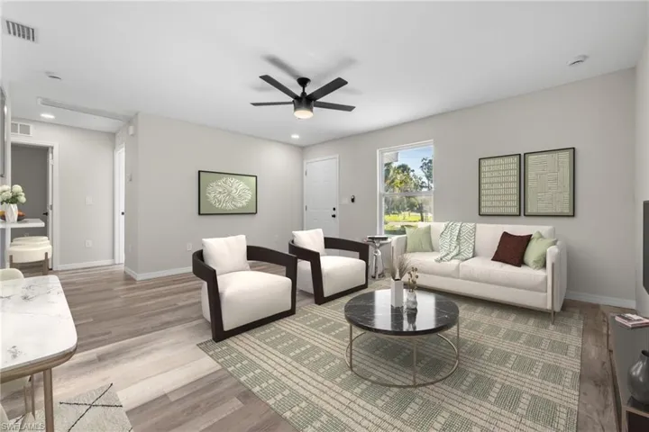 Living room with ceiling fan and light wood-type flooring