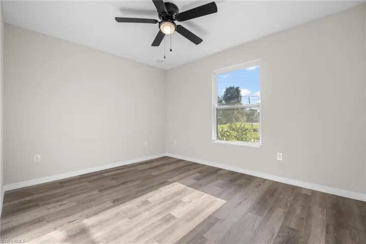 Spare room with ceiling fan and hardwood / wood-style flooring