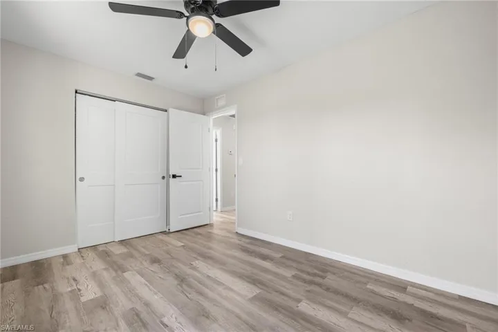 Unfurnished bedroom featuring a closet, ceiling fan, and light hardwood / wood-style flooring