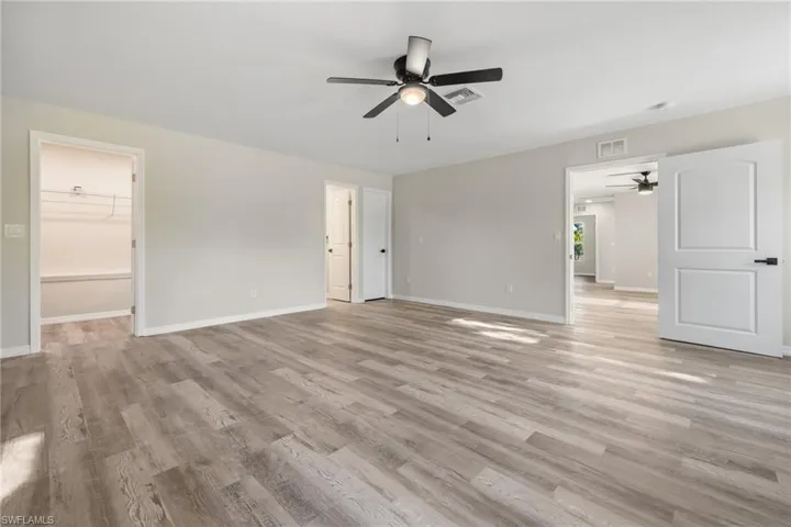 Spare room with ceiling fan and light hardwood / wood-style floors