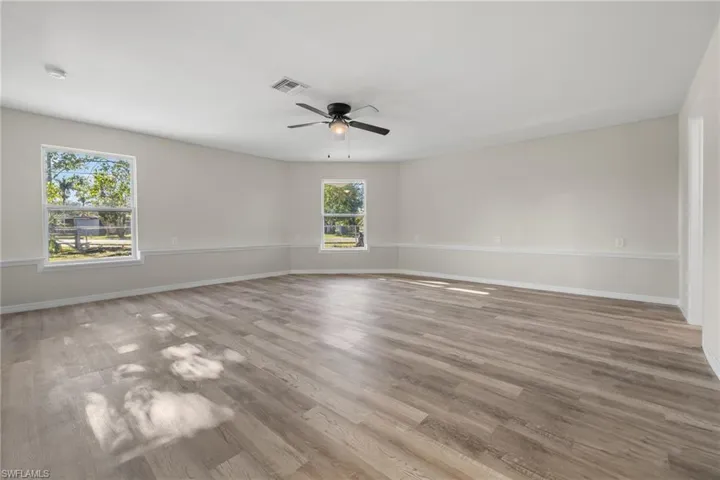Spare room with ceiling fan and light hardwood / wood-style floors