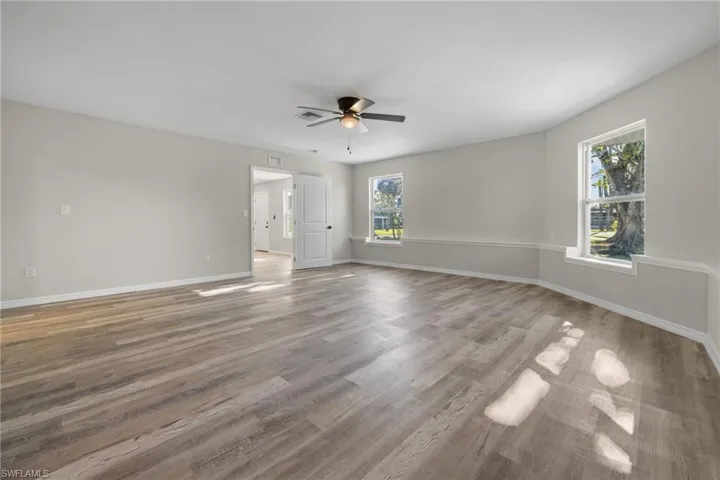 Unfurnished room with ceiling fan and hardwood / wood-style floors