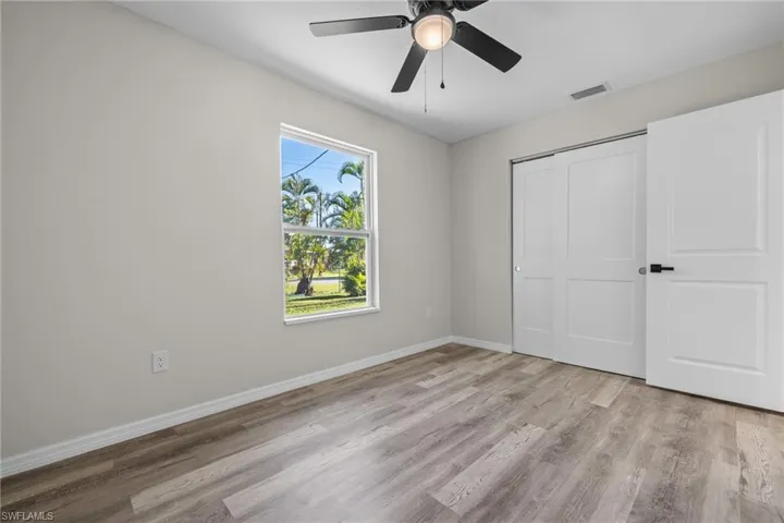 Unfurnished bedroom with ceiling fan, a closet, and light hardwood / wood-style flooring