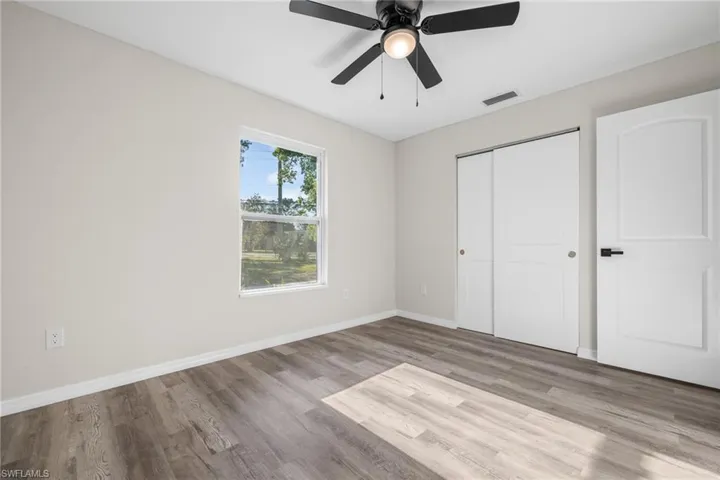 Unfurnished bedroom with ceiling fan, light hardwood / wood-style floors, and a closet