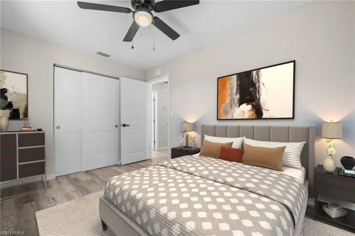 Bedroom featuring hardwood / wood-style floors, ceiling fan, and a closet