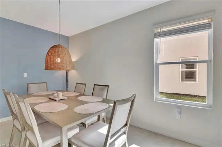 Dining area featuring light tile patterned flooring and baseboards