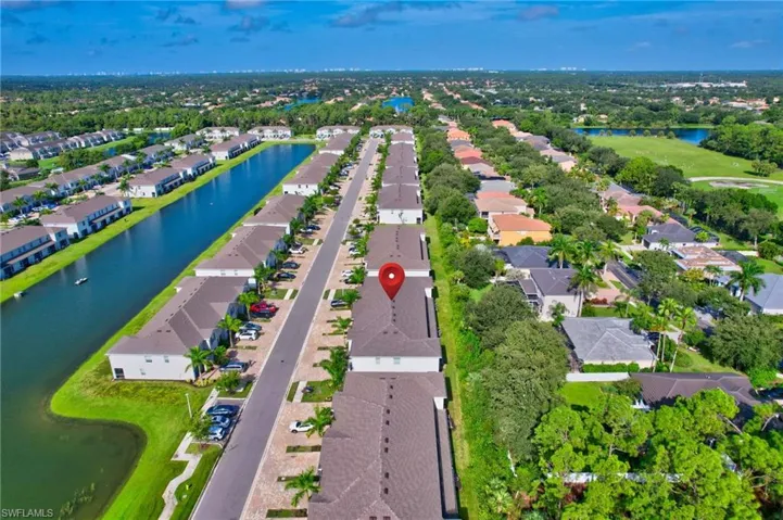 View of property location featuring a large body of water and nearby suburban area