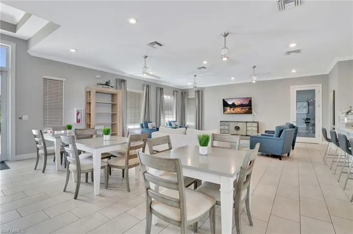Dining space with crown molding, recessed lighting, light tile patterned floors, and a ceiling fan
