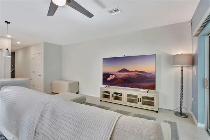 Tiled living area featuring recessed lighting and a ceiling fan