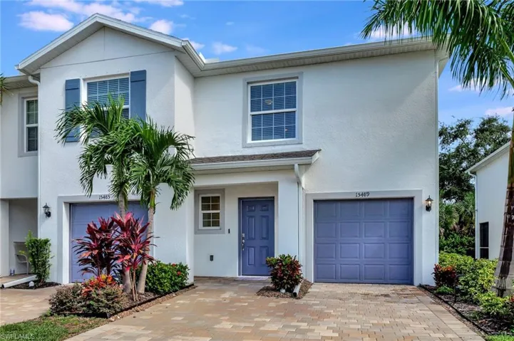 Traditional-style house featuring stucco siding and a garage