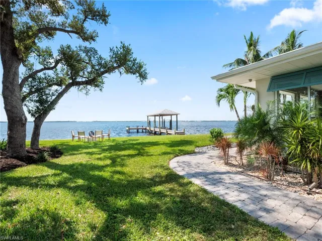 View of grassy yard featuring a water view and a gazebo