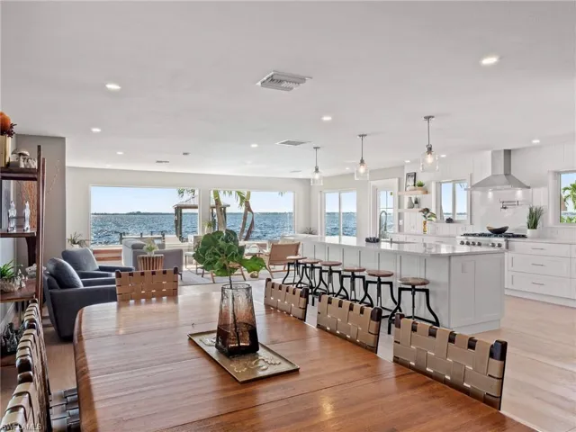 Dining room featuring a water view, light wood finished floors, and recessed lighting
