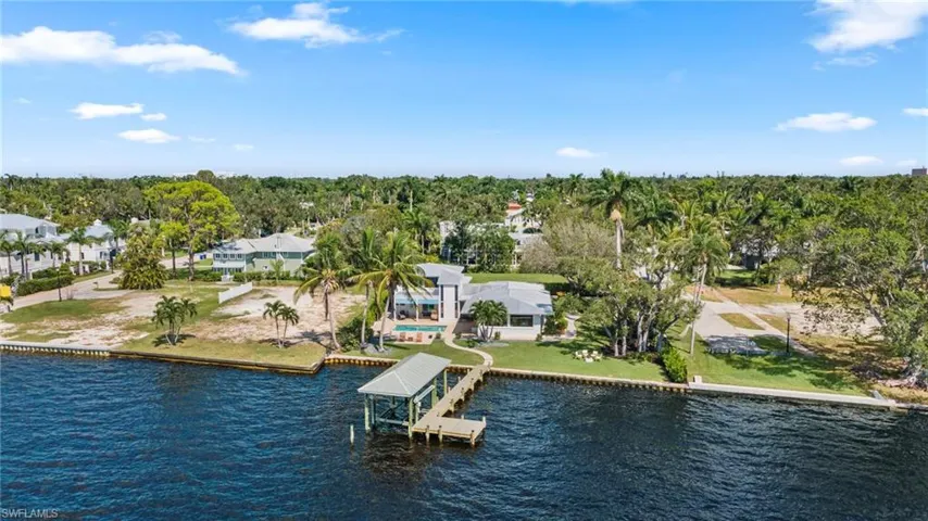 Aerial perspective of suburban area with a nearby body of water