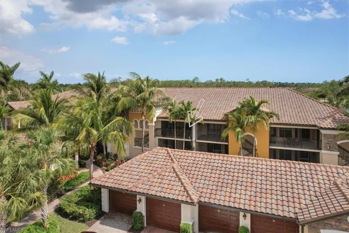 Mediterranean / spanish-style home with a tiled roof, stucco siding, and an attached garage