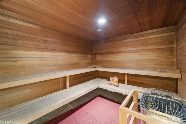 Sauna featuring wooden ceiling, wooden walls, and recessed lighting