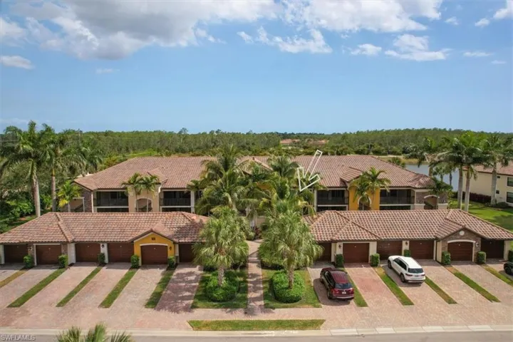 Mediterranean / spanish-style home featuring a tiled roof and community garages
