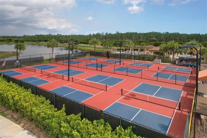 View of tennis court featuring a water view