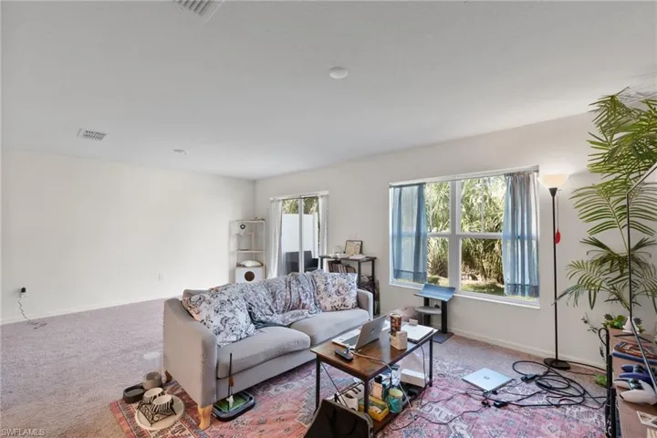Carpeted living area featuring baseboards