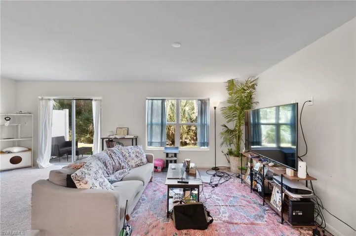 Living area featuring baseboards and carpet floors
