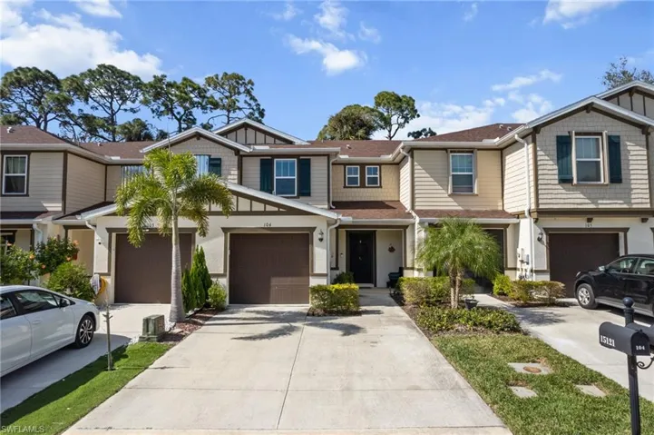 Craftsman-style home featuring driveway, an attached garage, and a residential view
