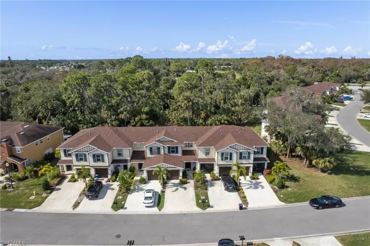 Aerial view of property and surrounding area featuring a heavily wooded area