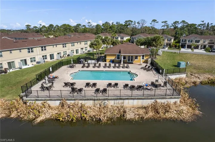 Rear view of property with a water view, a fenced backyard, and a residential view