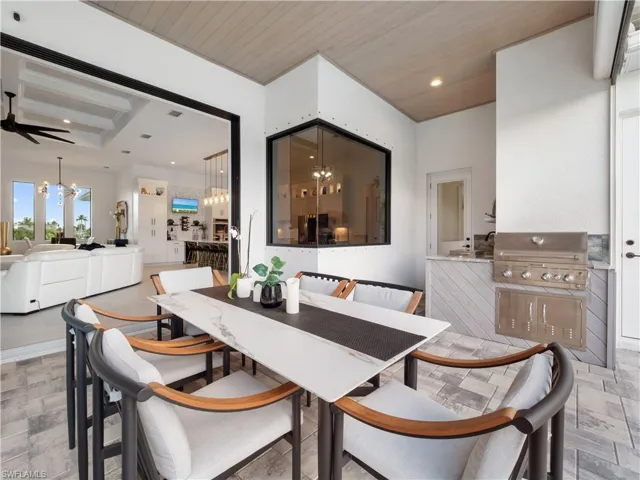 Dining space with suspended lighting, a ceiling fan, and wooden ceiling