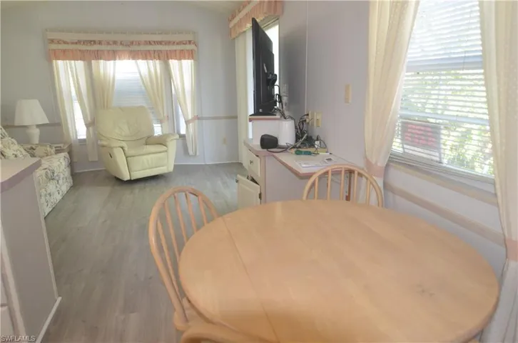 Dining area featuring light wood-style flooring, plenty of natural light, and lofted ceiling