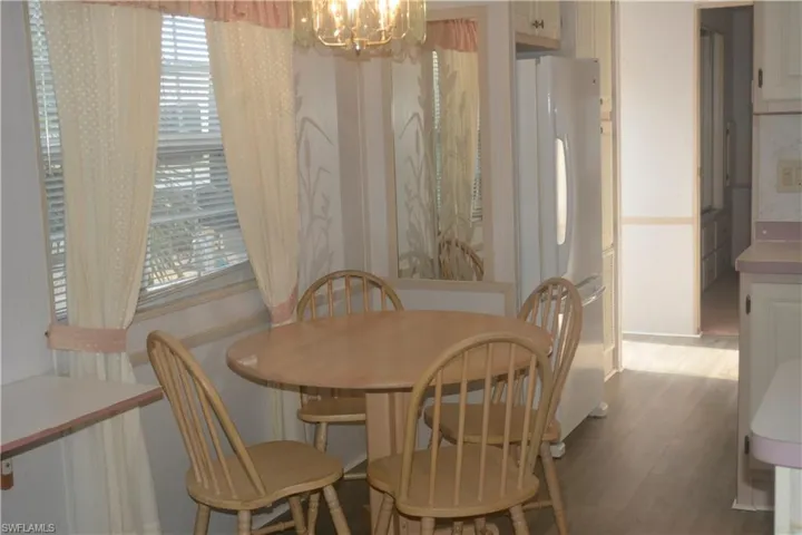 Dining space featuring a notable chandelier and light wood finished floors