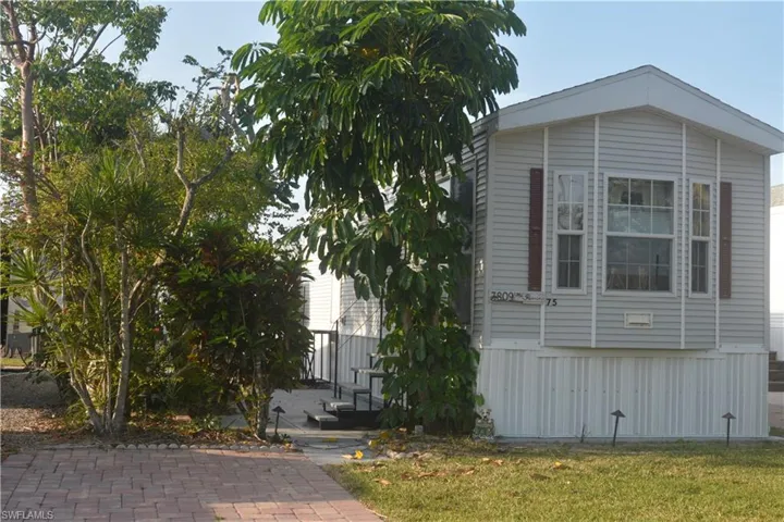 View of side of property with a yard