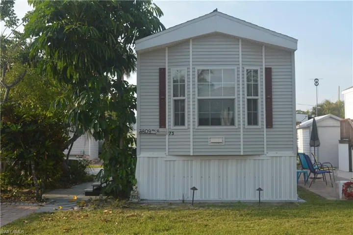 View of home's exterior featuring a lawn and a patio area