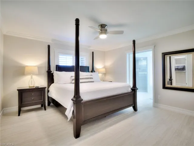 Neutral color palette featuring wood-finish flooring and crown molding