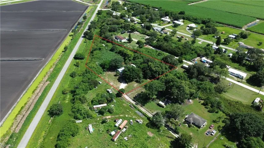 Aerial view of sparsely populated area with property boundaries highlighted