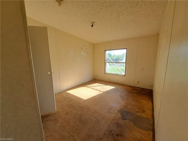 Empty room with a textured ceiling