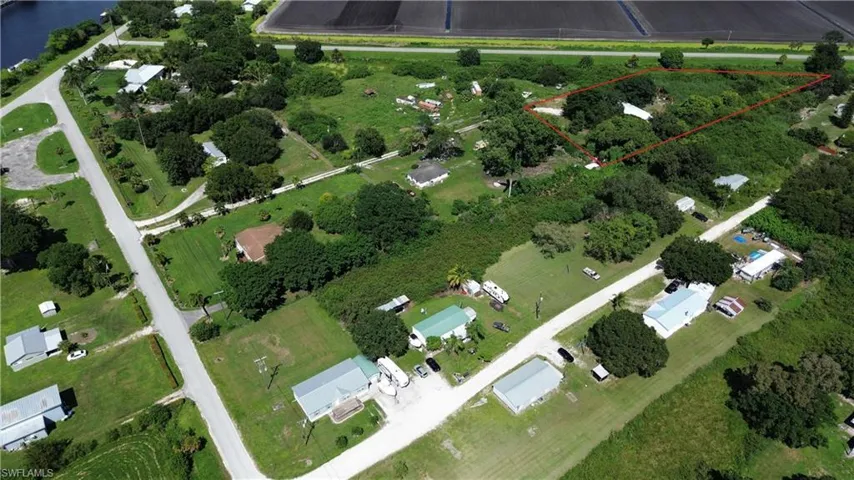 Aerial view of property and surrounding area featuring property boundaries highlighted