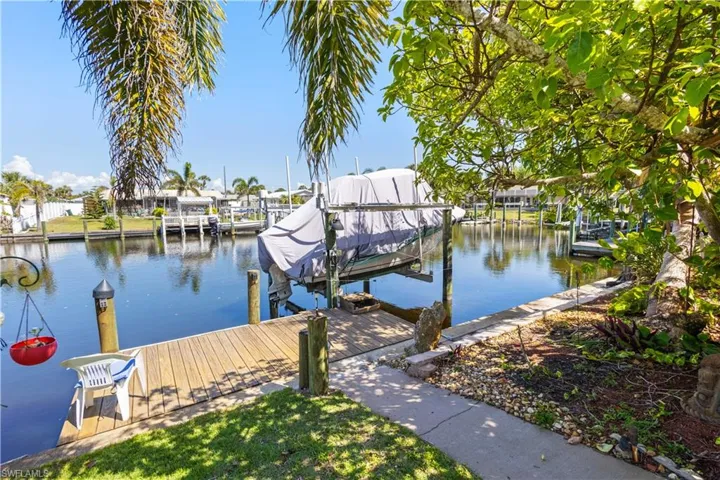 Dock area with boat lift and a water view