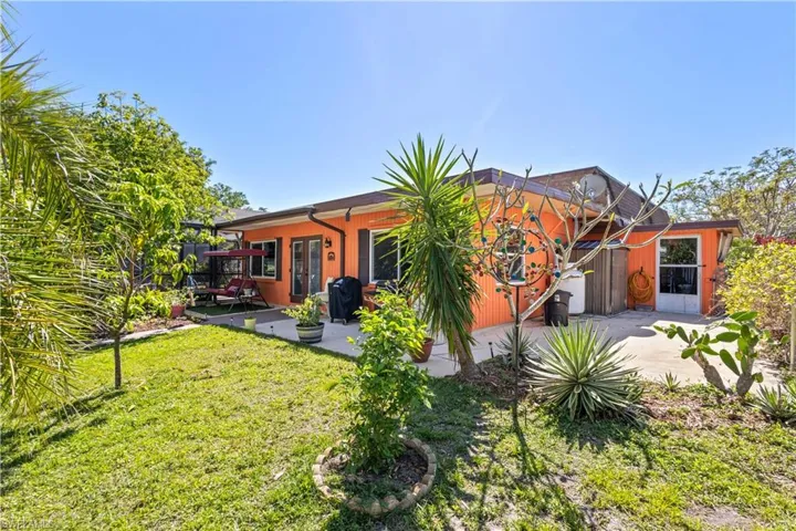 Back of house featuring a patio area and a lawn